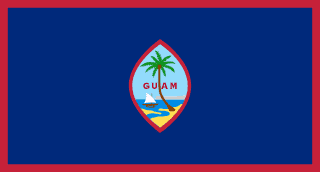 The flag of Guam is dark blue with a narrow red border on all four sides. Centered is a red-bordered, pointed, vertical ellipse containing a beach scene, a proa (outrigger canoe with sail), and a palm tree. The country's name in red is centered in the ellipse.