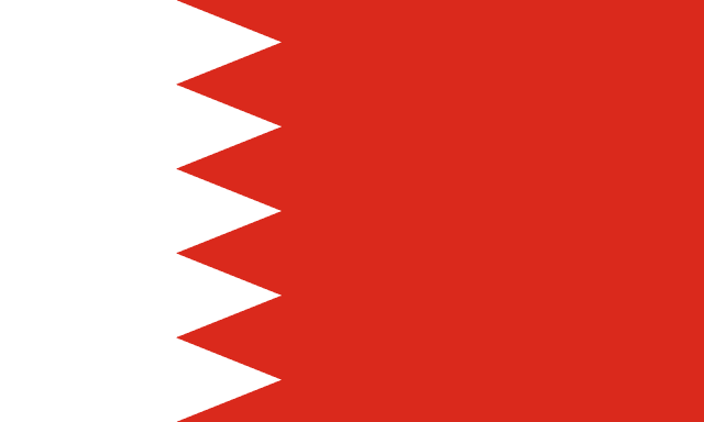 The flag of Bahrain has a red field. On the hoist side, it features a white vertical band that spans about one-third the width of the field and is separated from the rest of the field by five adjoining fly-side pointing white isosceles triangles that serve as a serrated line.