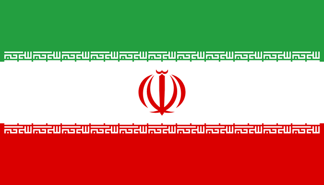 The flag of Iran is composed of three equal horizontal bands of green, white and red. A red emblem of Iran is centered in the white band and Arabic inscriptions in white span the bottom edge of the green band and the top edge of the red band.