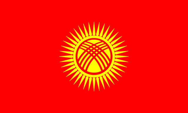 The flag of Kyrgyzstan features a yellow sun with forty rays at the center of a red field. At the center of the sun is a stylized depiction of a tunduk.