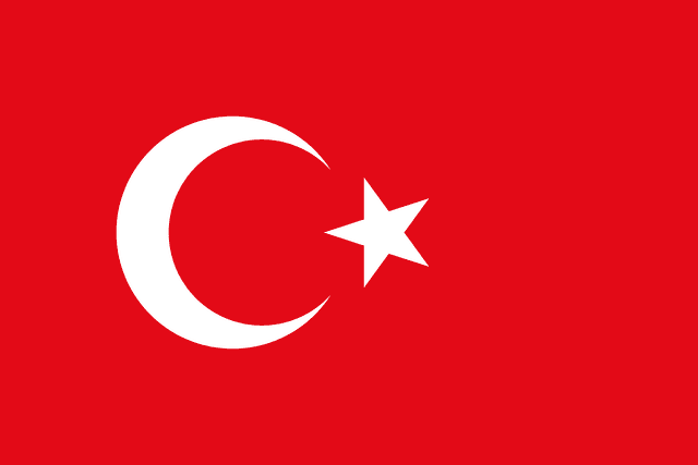 The flag of Turkey has a red field bearing a large fly-side facing white crescent and a smaller five-pointed white star placed just outside the crescent opening. The white crescent and star are offset slightly towards the hoist side of center.